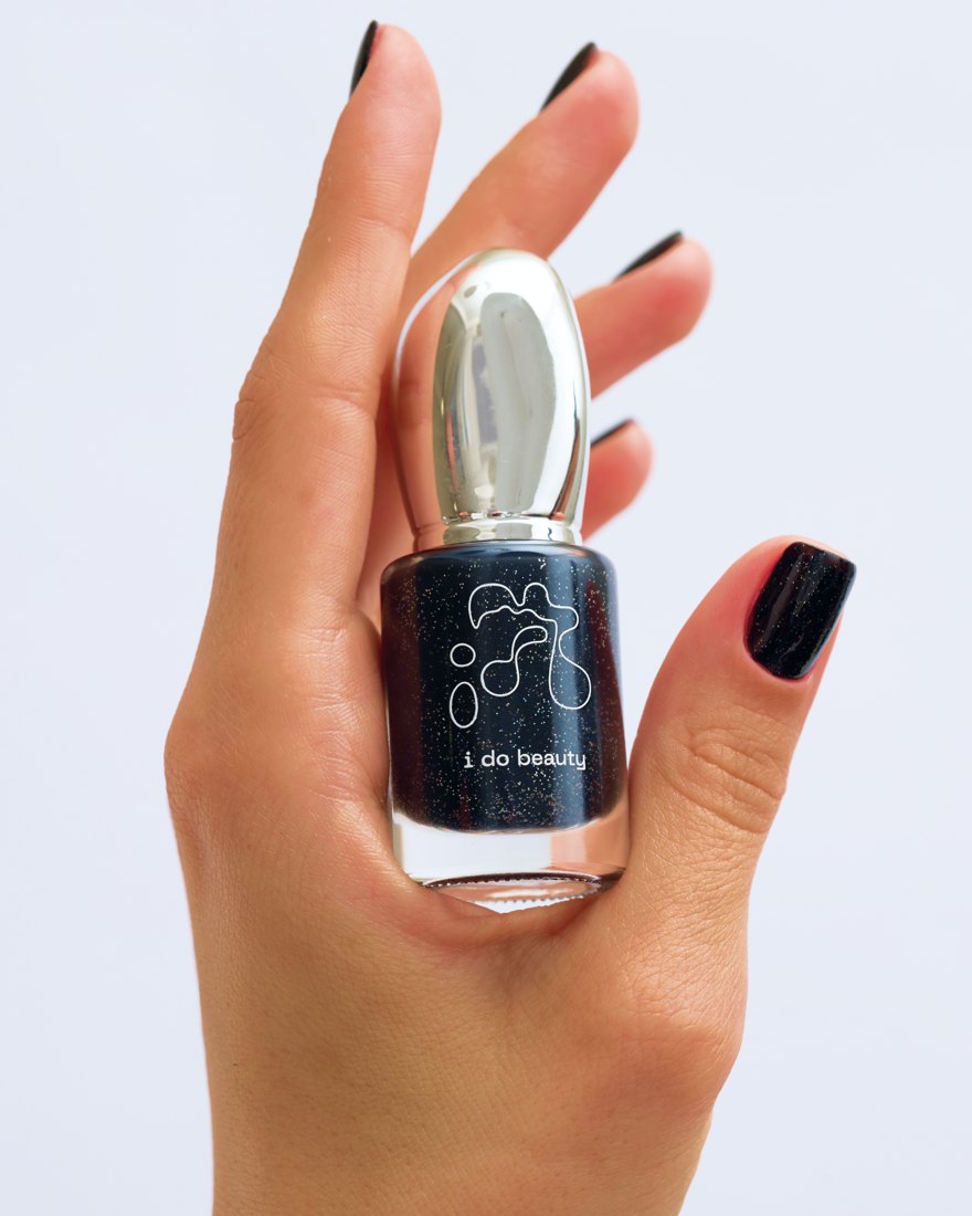 Black glitter lacquer in hand